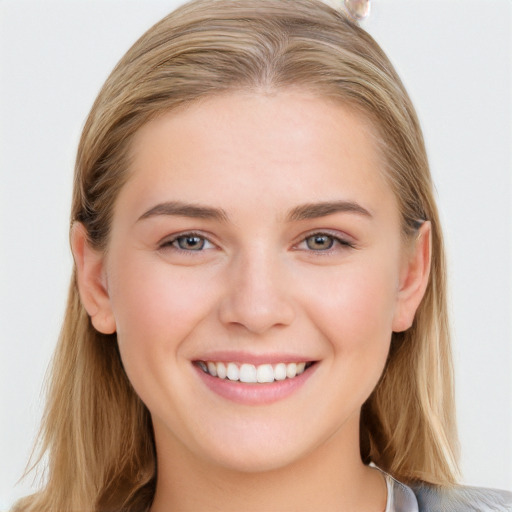 Joyful white young-adult female with long  brown hair and blue eyes