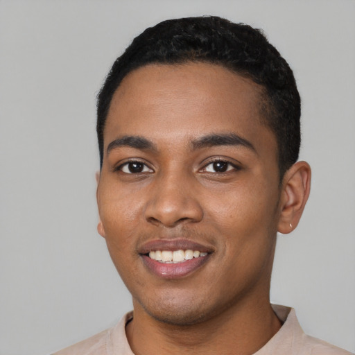 Joyful black young-adult male with short  black hair and brown eyes