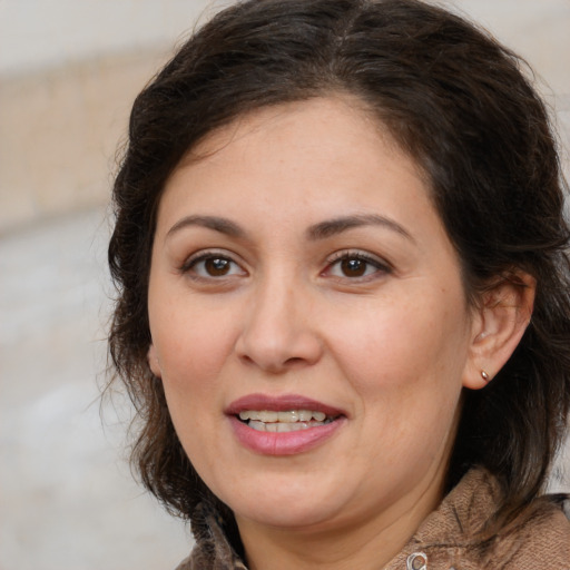 Joyful white adult female with medium  brown hair and brown eyes