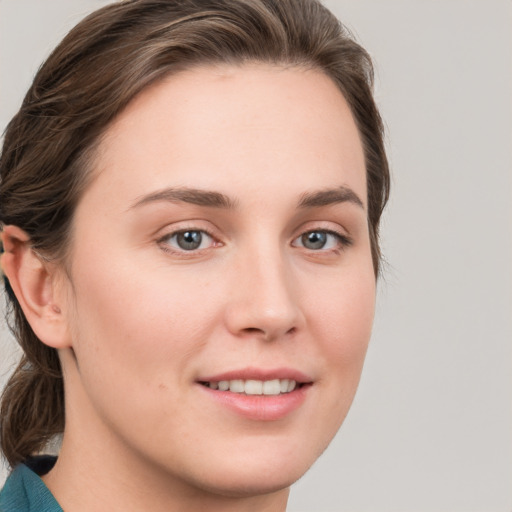 Joyful white young-adult female with medium  brown hair and blue eyes