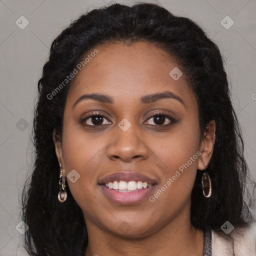 Joyful black young-adult female with long  black hair and brown eyes