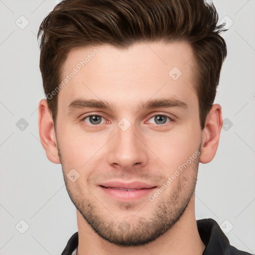 Joyful white young-adult male with short  brown hair and grey eyes