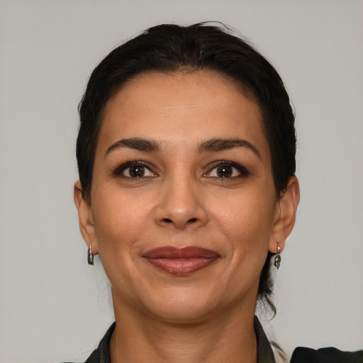 Joyful latino adult female with short  brown hair and brown eyes