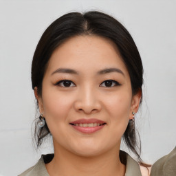 Joyful asian young-adult female with medium  brown hair and brown eyes