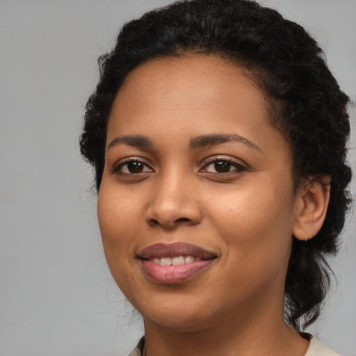 Joyful latino young-adult female with medium  black hair and brown eyes