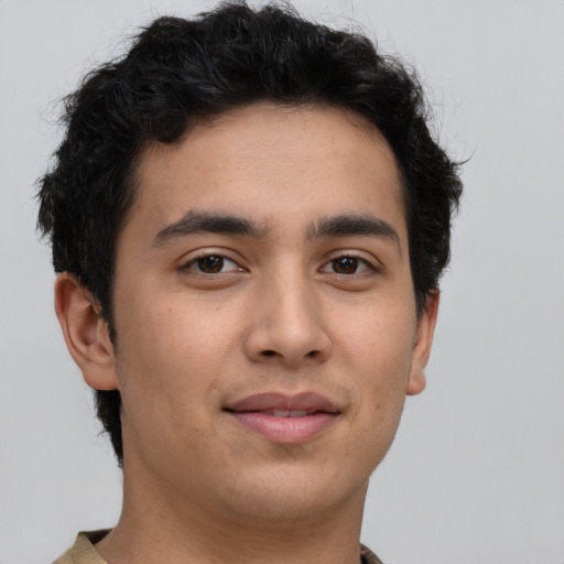 Joyful latino young-adult male with short  brown hair and brown eyes