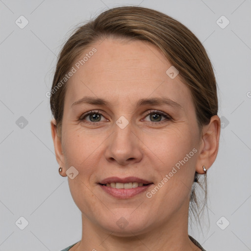 Joyful white adult female with medium  brown hair and grey eyes