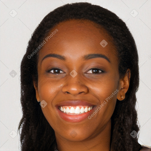 Joyful black young-adult female with long  black hair and brown eyes