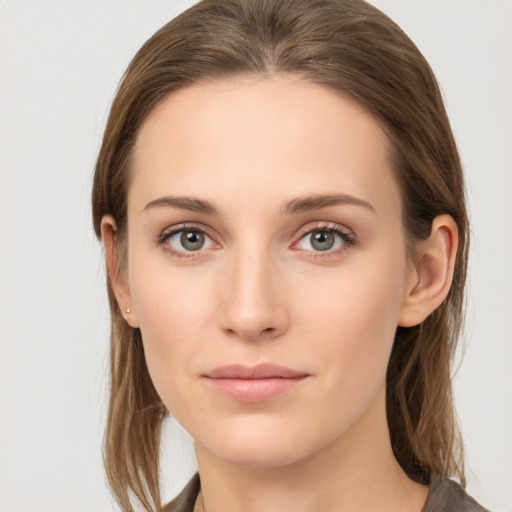 Joyful white young-adult female with long  brown hair and grey eyes