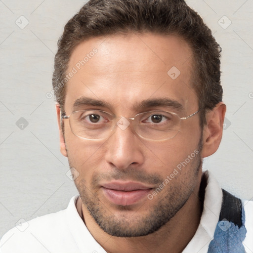 Joyful white adult male with short  brown hair and brown eyes