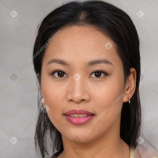 Joyful asian young-adult female with long  black hair and brown eyes