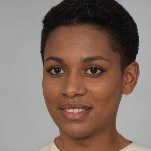 Joyful black young-adult female with short  brown hair and brown eyes