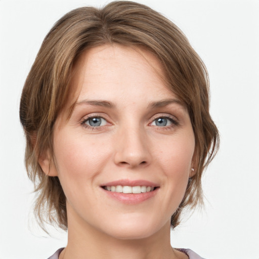 Joyful white young-adult female with medium  brown hair and blue eyes