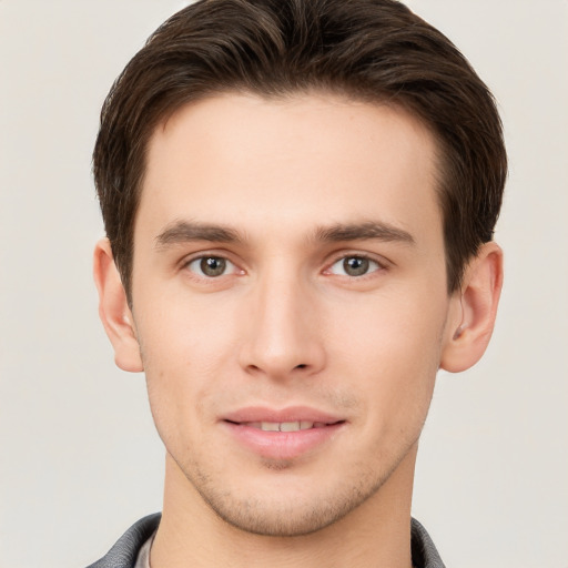 Joyful white young-adult male with short  brown hair and brown eyes