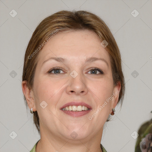 Joyful white adult female with medium  brown hair and grey eyes