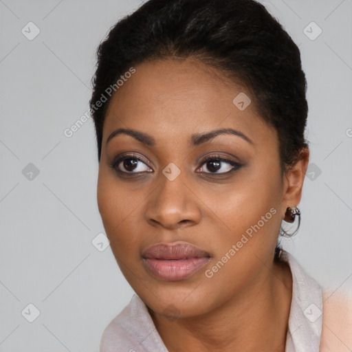 Joyful black young-adult female with short  black hair and brown eyes