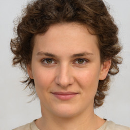 Joyful white young-adult female with medium  brown hair and green eyes