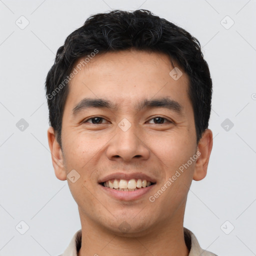 Joyful asian young-adult male with short  brown hair and brown eyes