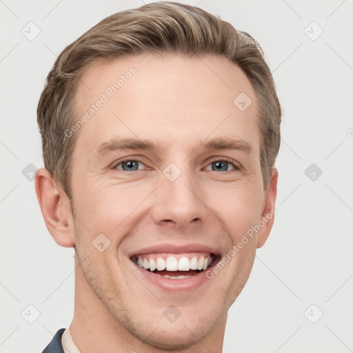 Joyful white young-adult male with short  brown hair and grey eyes