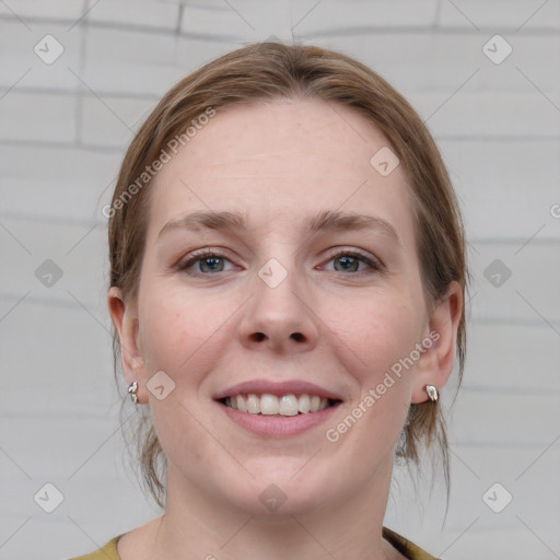 Joyful white young-adult female with medium  brown hair and blue eyes