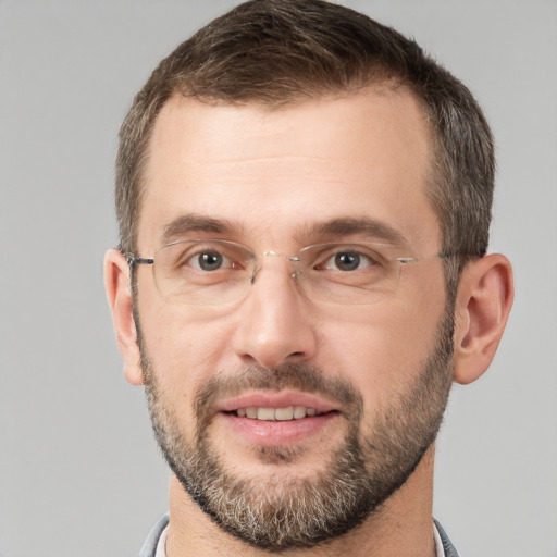 Joyful white adult male with short  brown hair and brown eyes