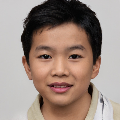 Joyful asian child male with short  brown hair and brown eyes