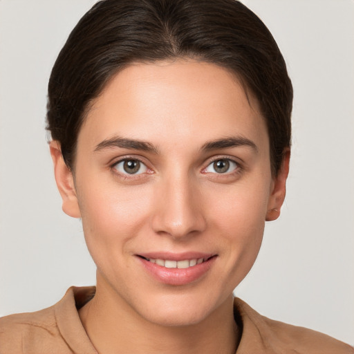 Joyful white young-adult female with short  brown hair and brown eyes