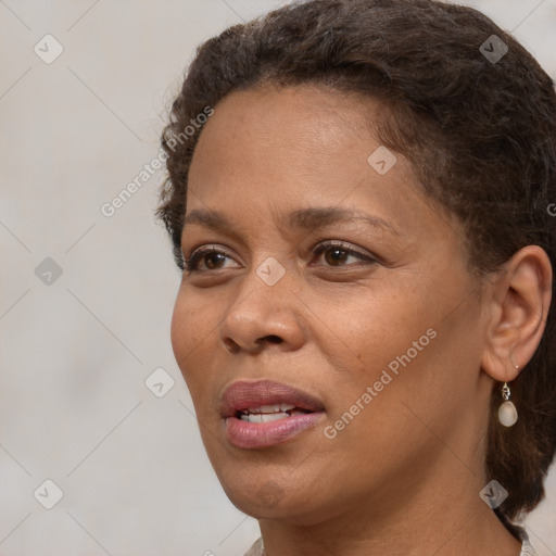 Joyful black adult female with short  brown hair and brown eyes