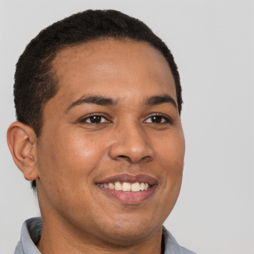 Joyful latino young-adult male with short  brown hair and brown eyes