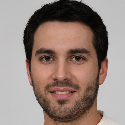 Joyful white young-adult male with short  black hair and brown eyes