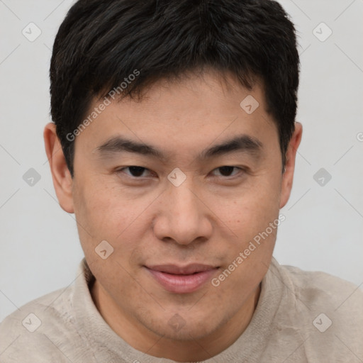 Joyful asian young-adult male with short  brown hair and brown eyes