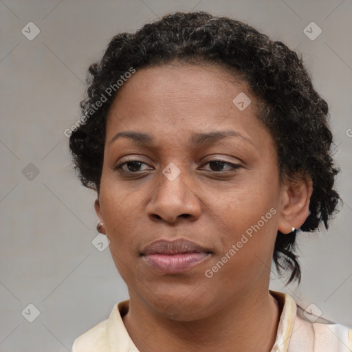 Joyful black adult female with short  brown hair and brown eyes