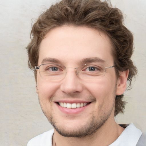 Joyful white young-adult male with short  brown hair and green eyes