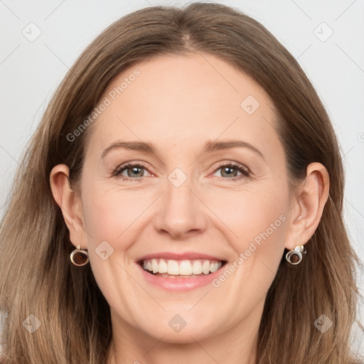 Joyful white adult female with long  brown hair and grey eyes