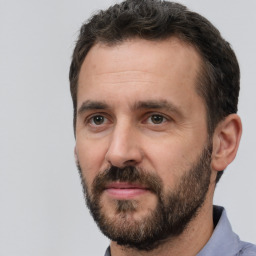 Joyful white adult male with short  brown hair and brown eyes