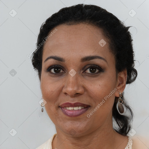 Joyful black adult female with short  brown hair and brown eyes