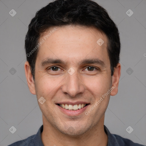 Joyful white adult male with short  brown hair and brown eyes