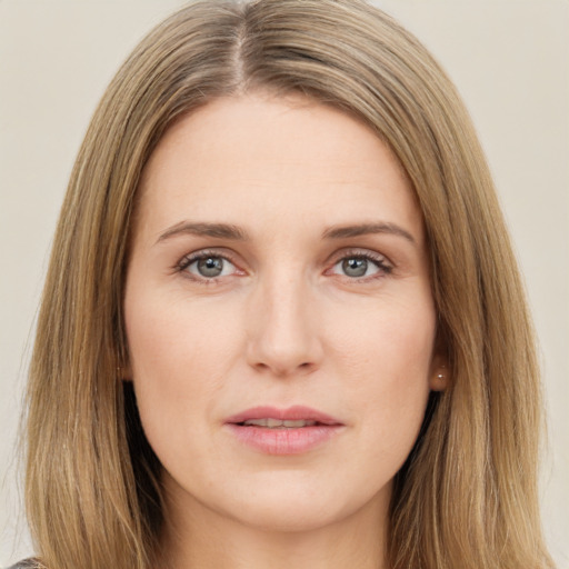 Joyful white young-adult female with long  brown hair and green eyes