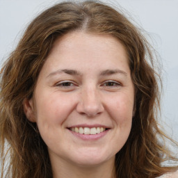 Joyful white adult female with long  brown hair and brown eyes