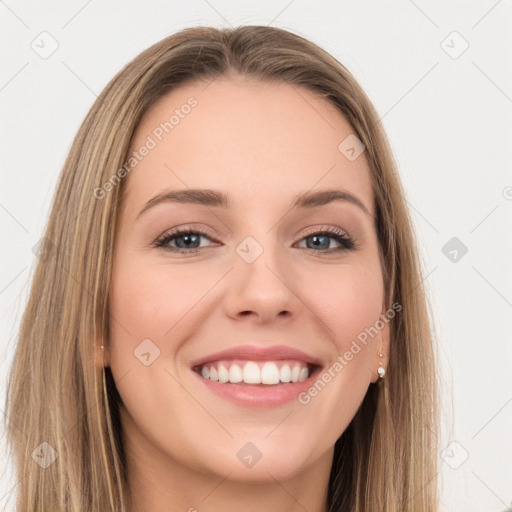 Joyful white young-adult female with long  brown hair and green eyes