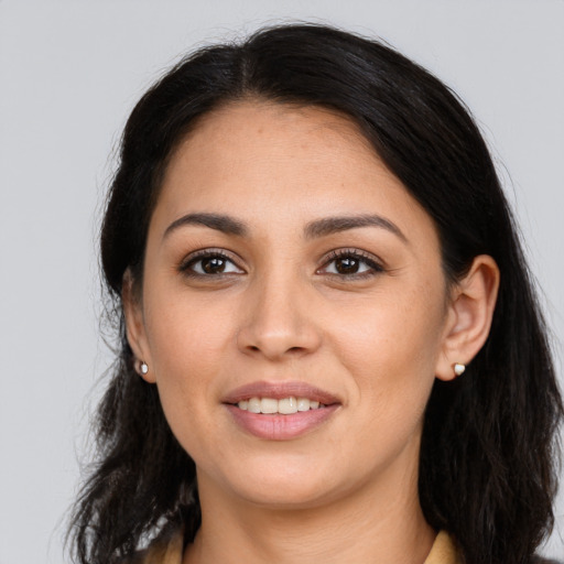 Joyful latino young-adult female with long  brown hair and brown eyes