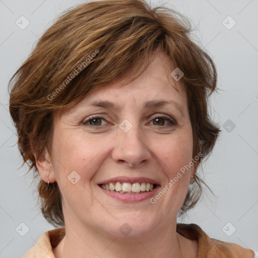 Joyful white adult female with medium  brown hair and blue eyes