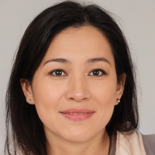 Joyful asian young-adult female with long  brown hair and brown eyes