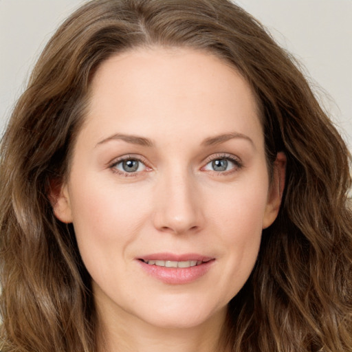 Joyful white young-adult female with long  brown hair and green eyes