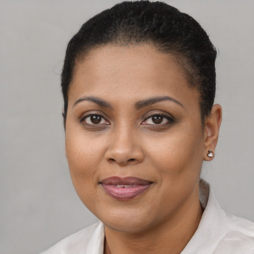 Joyful black young-adult female with short  brown hair and brown eyes