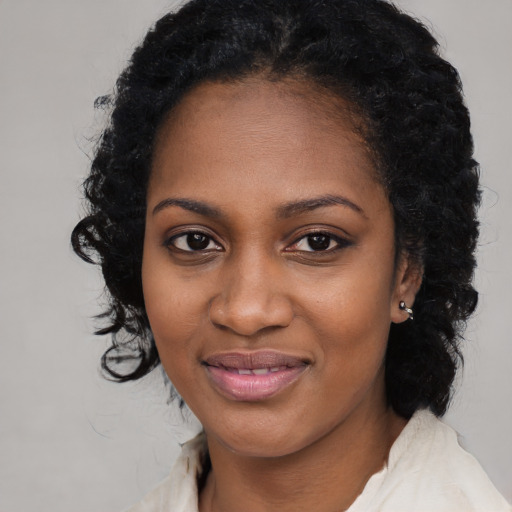 Joyful black young-adult female with medium  black hair and brown eyes