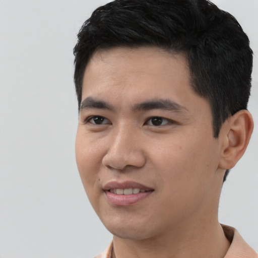 Joyful asian young-adult male with short  black hair and brown eyes