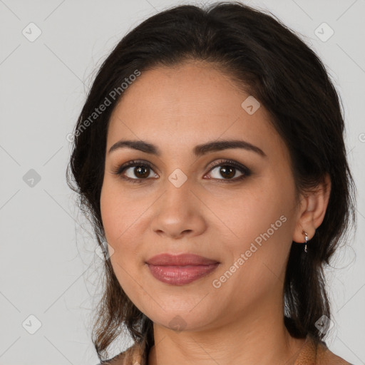 Joyful latino young-adult female with medium  brown hair and brown eyes