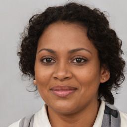 Joyful black adult female with medium  brown hair and brown eyes