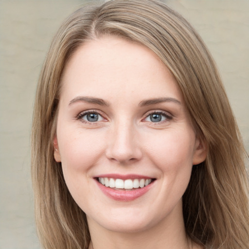 Joyful white young-adult female with long  brown hair and green eyes